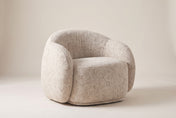 Lowell accent chair in Beige, three-quarter view on a warm off-white studio backdrop: a rounded bucket back curving into thic