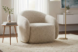 Lowell beige textured accent chair on a shag rug beside a side table and floor lamp