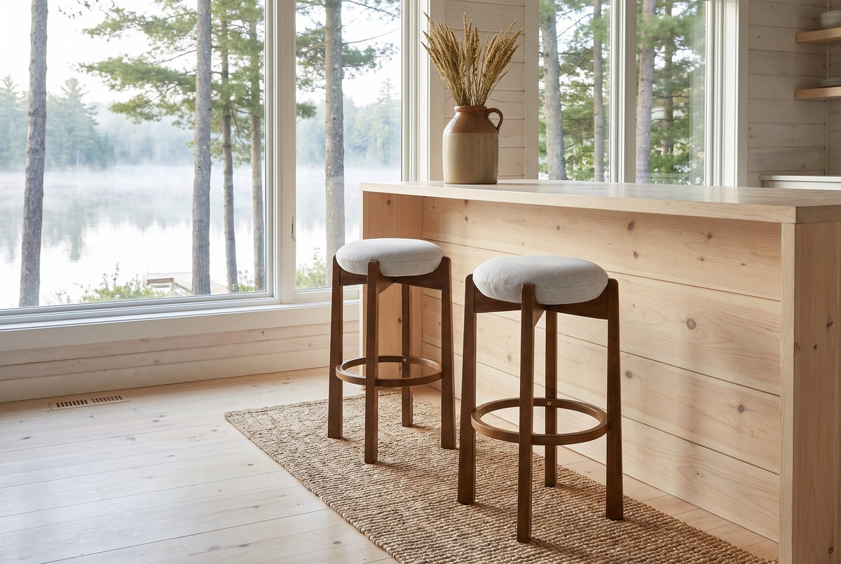 Two Lucera bar stools on a jute runner at a pale pine counter by a lake window in a Muskoka cottage