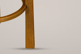 Close-up of a square Walnut rubberwood leg with the curved footrest ring joined to its inner face