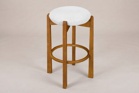 Lucera backless bar stool in Walnut, three-quarter view on a warm light-grey studio backdrop