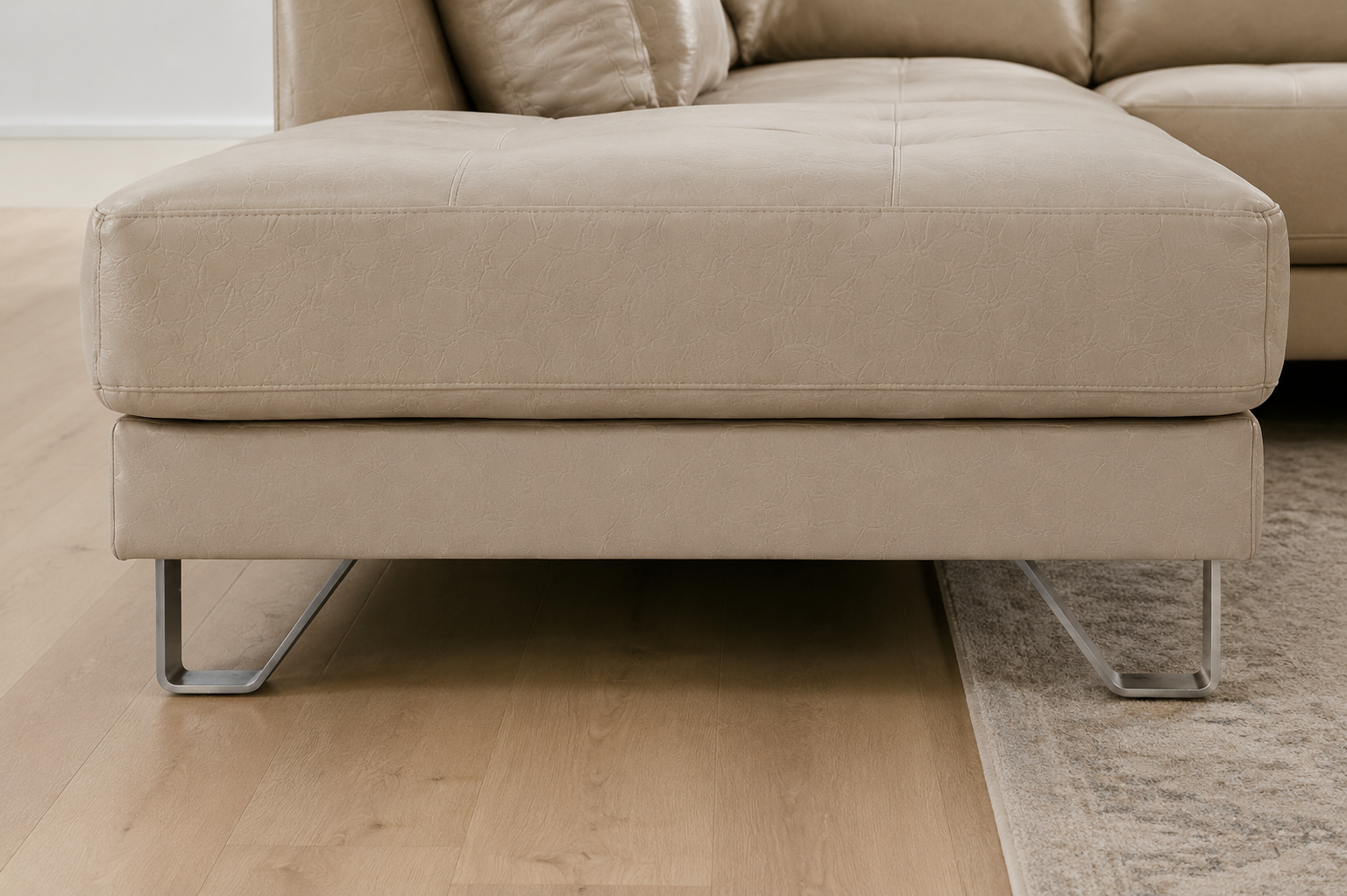 Lucien bisque leather sectional right bumper, back view showing full upholstery