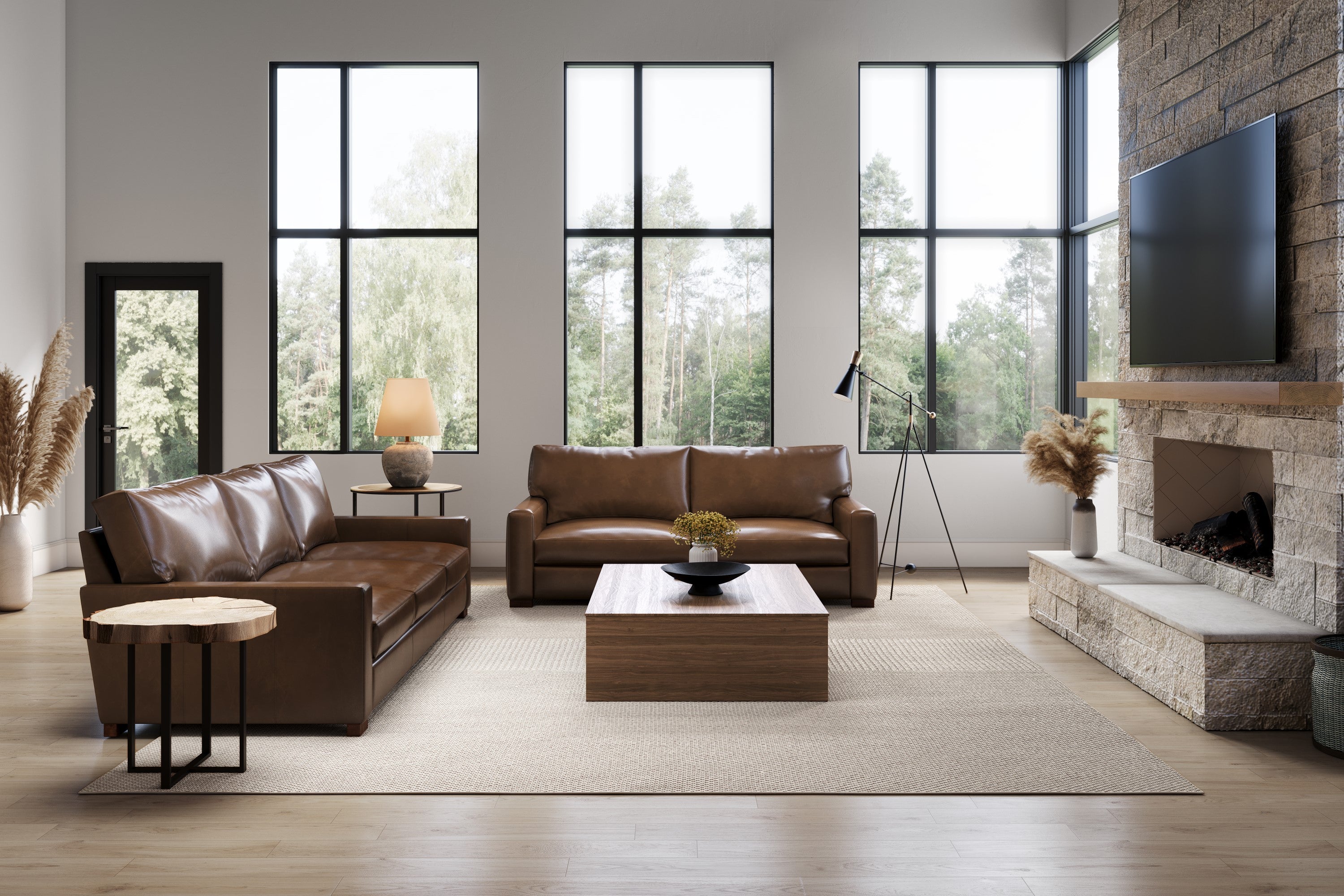 In a Large Living Room, There are Sitting Two Sofas, One is Loveseat and Other One is Three Seats, In Front of These There is a Mini Table with Flower Jar.