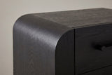 Close-up of the rounded waterfall corner, the seam to the flat top and the end of a black bar handle