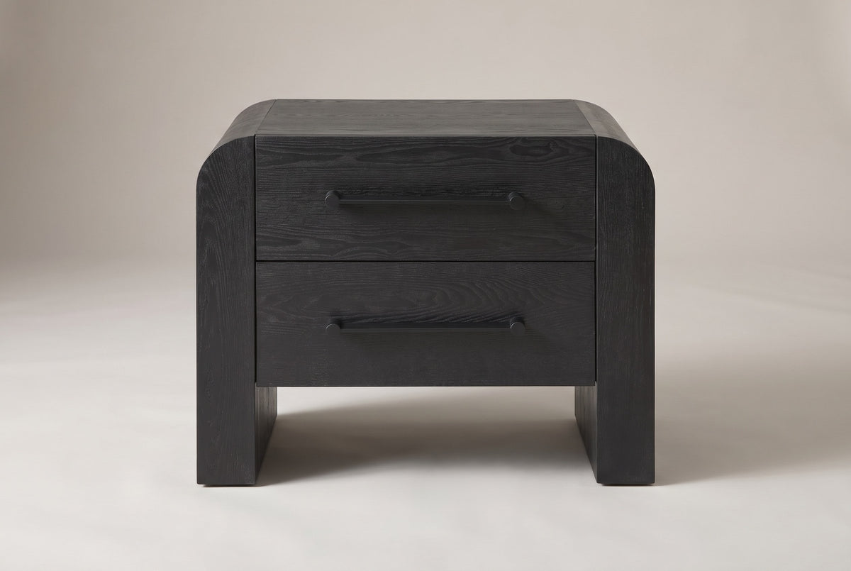 Macerata nightstand in black, straight front view: two drawers, two slim black bar handles, rounded slab sides