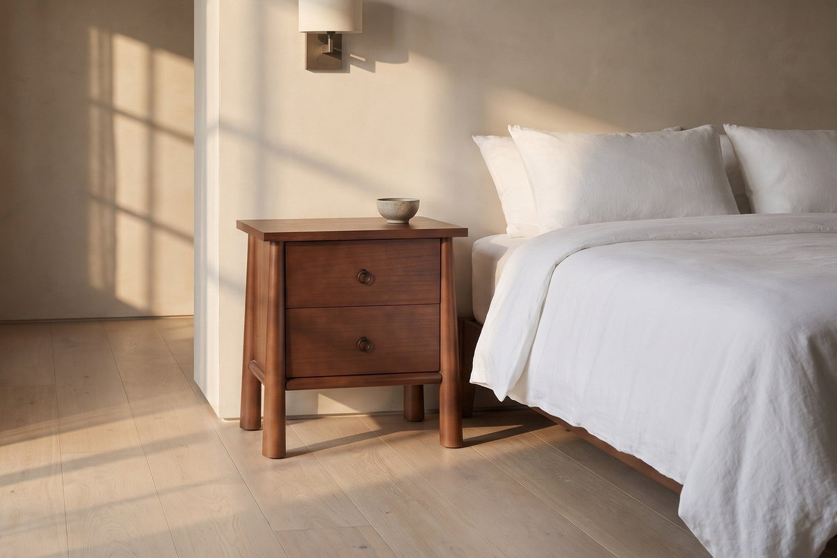 Malcesine nightstand beside a bed in a plaster bedroom at golden hour