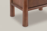 Close-up of a round front post with its rounded foot and the rounded rails under the drawer and along the side