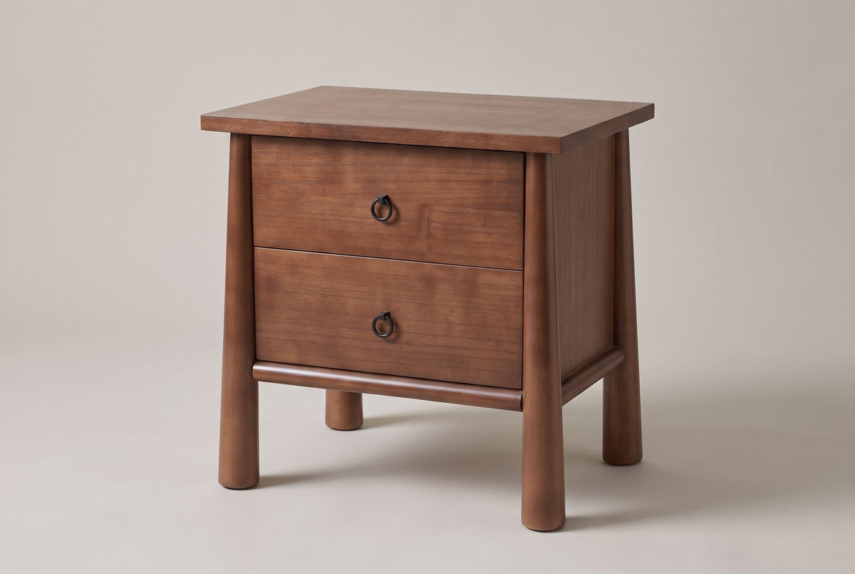 Malcesine nightstand in walnut brown, three-quarter view on a warm grey studio backdrop
