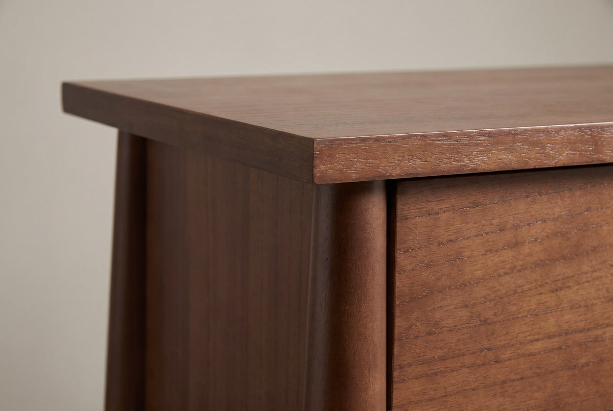 Close-up of the square top corner over a round post, the side panel and the upper drawer