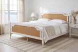 Manarola bed made up with white linen in a white shiplap bedroom by the harbour, morning light