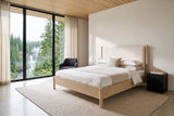 Manciano bed in light natural wood with an off-white cushion headboard in a bedroom in a Clearwater house near Wells Gray