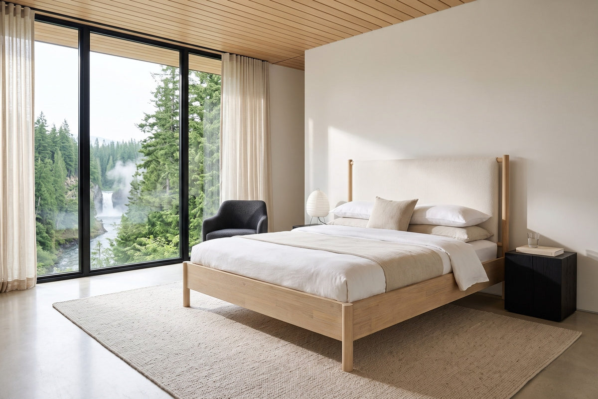 Manciano bed in light natural wood with an off-white cushion headboard in a bedroom in a Clearwater house near Wells Gray