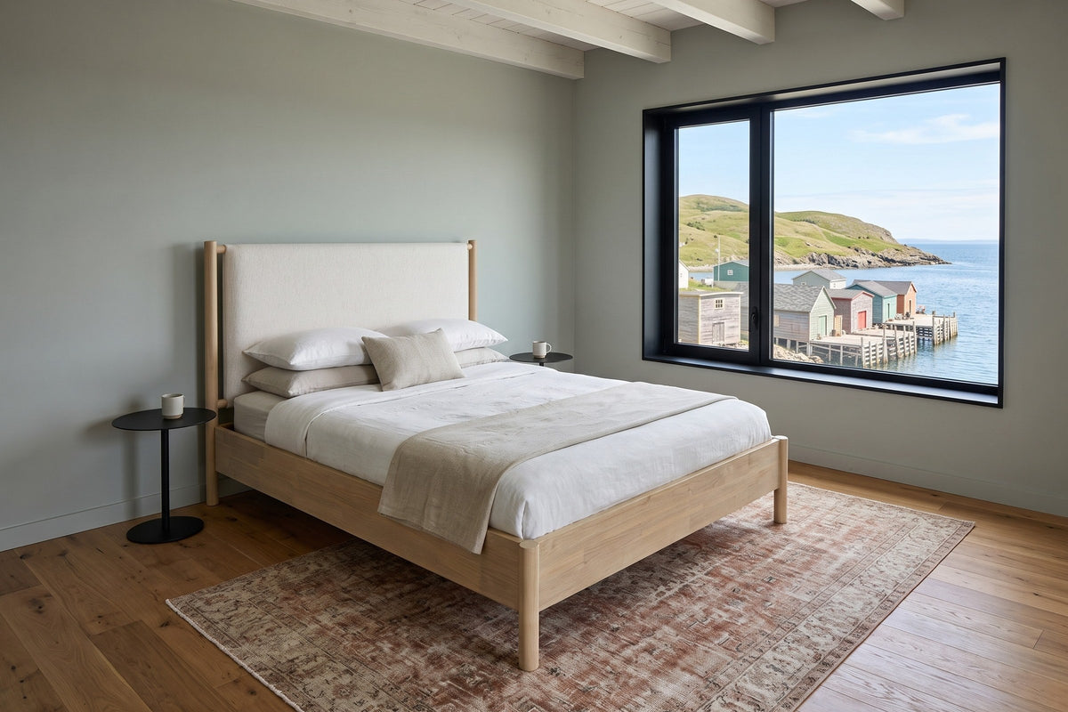 Manciano bed in a bedroom in a Salvage house in Newfoundland, raised three-quarter view, with sage limewash