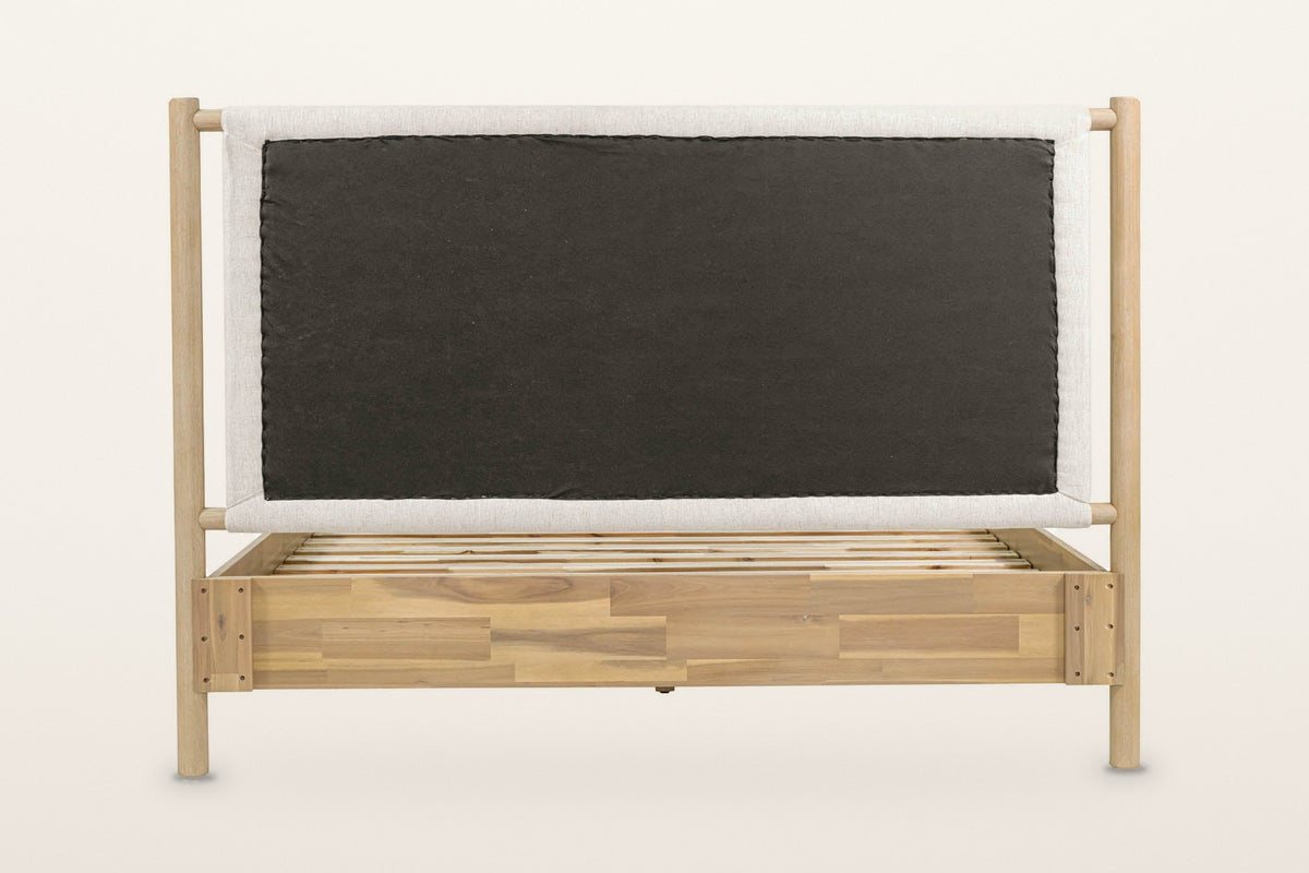 Manciano bed from behind the headboard on a warm white studio backdrop: the back of the cushion between the two head posts