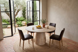 Marano round dining table seen from above at the corner in a Sintra villa, with greige limewash, terracotta tiles