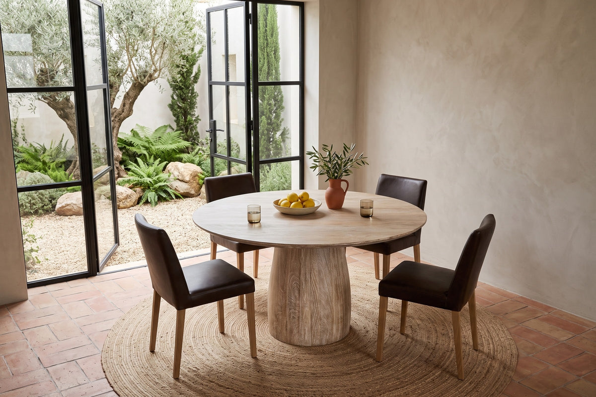 Marano round dining table seen from above at the corner in a Sintra villa, with greige limewash, terracotta tiles