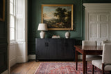 The Maren cabinet in Black below a gilt-framed landscape, in a deep green Georgian dining room in Bath with a Persian rug
