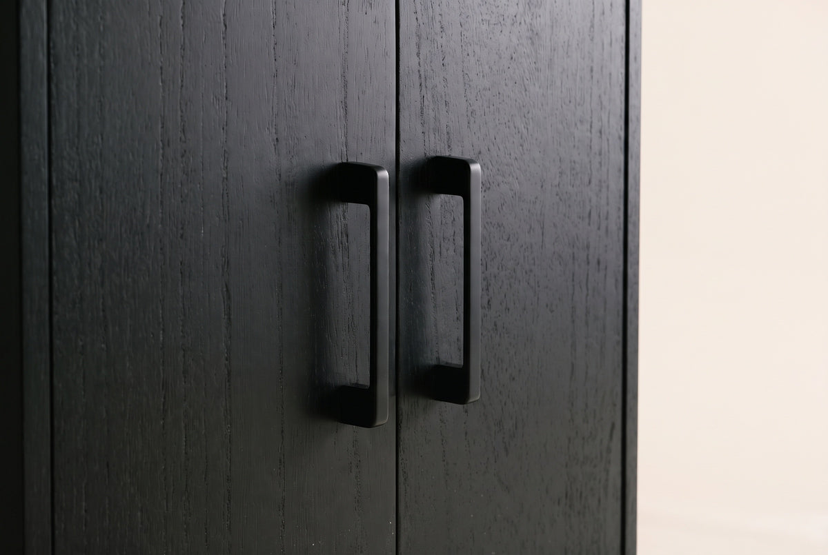 Close-up of two Maren cabinet doors in Black meeting in the middle, with their two slim black metal handles