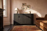 The Maren cabinet in Black below three small etchings, in a plaster-pink Victorian living room in London with a tobacco velvet sofa