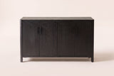 The Maren storage cabinet in Black seen straight on, with its two pairs of doors and four black bar handles