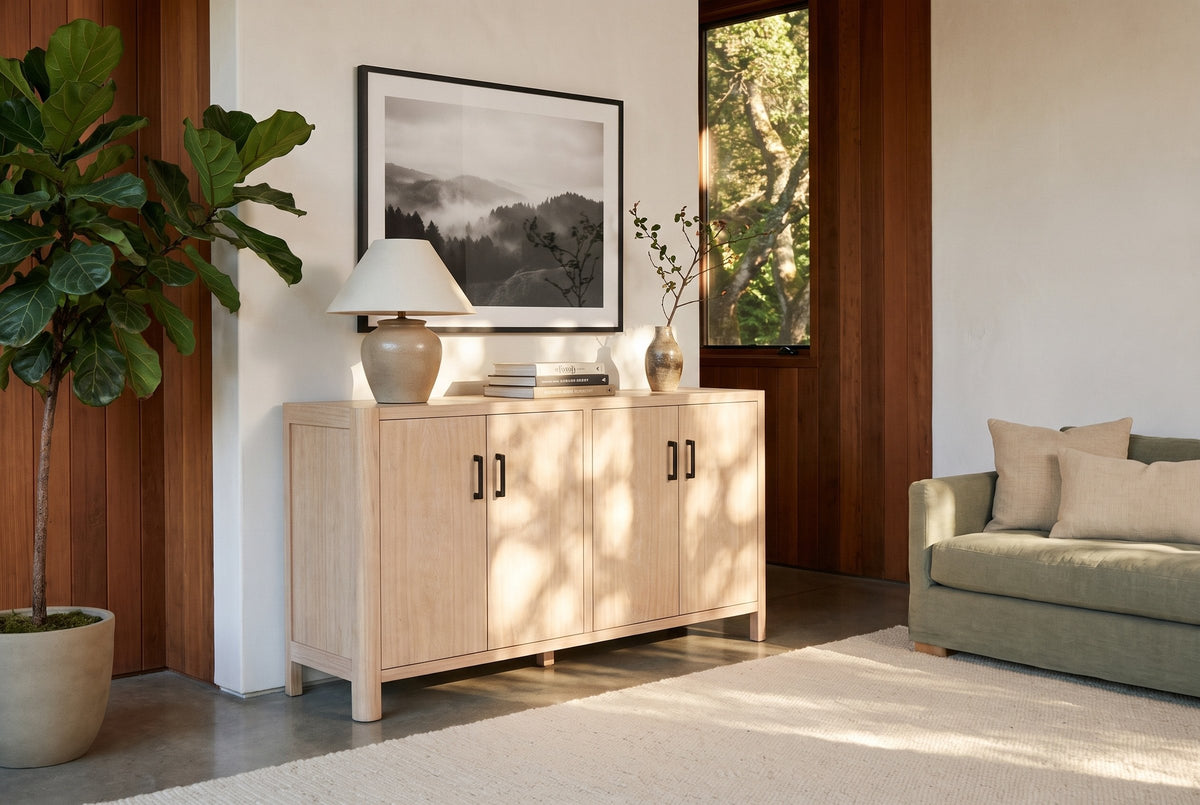 The Maren cabinet in Natural below a misty landscape photograph, in a Mill Valley redwood house with a sage linen sofa