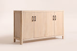 The Maren storage cabinet in Natural, front three-quarter view: four wood veneer doors with slim black handles, softly rounded corners and short solid pine legs, on an off-white studio background