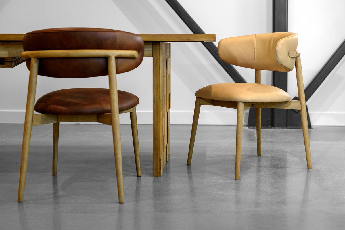 Marlow dining chairs in Tobacco and Hazelnut leather at a wood dining table