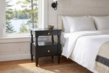 Marsala nightstand in Black beside a bed in a whitewashed pine Muskoka cottage bedroom with a lake view