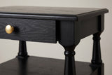 Close-up of the Marsala top corner: the moulded edge, the upper drawer knob and a turned post under a chamfered corner block