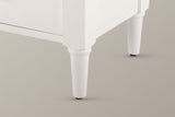 Close-up of a Marsala front leg in Milk White: the white chamfered corner stile and the turned, tapered leg