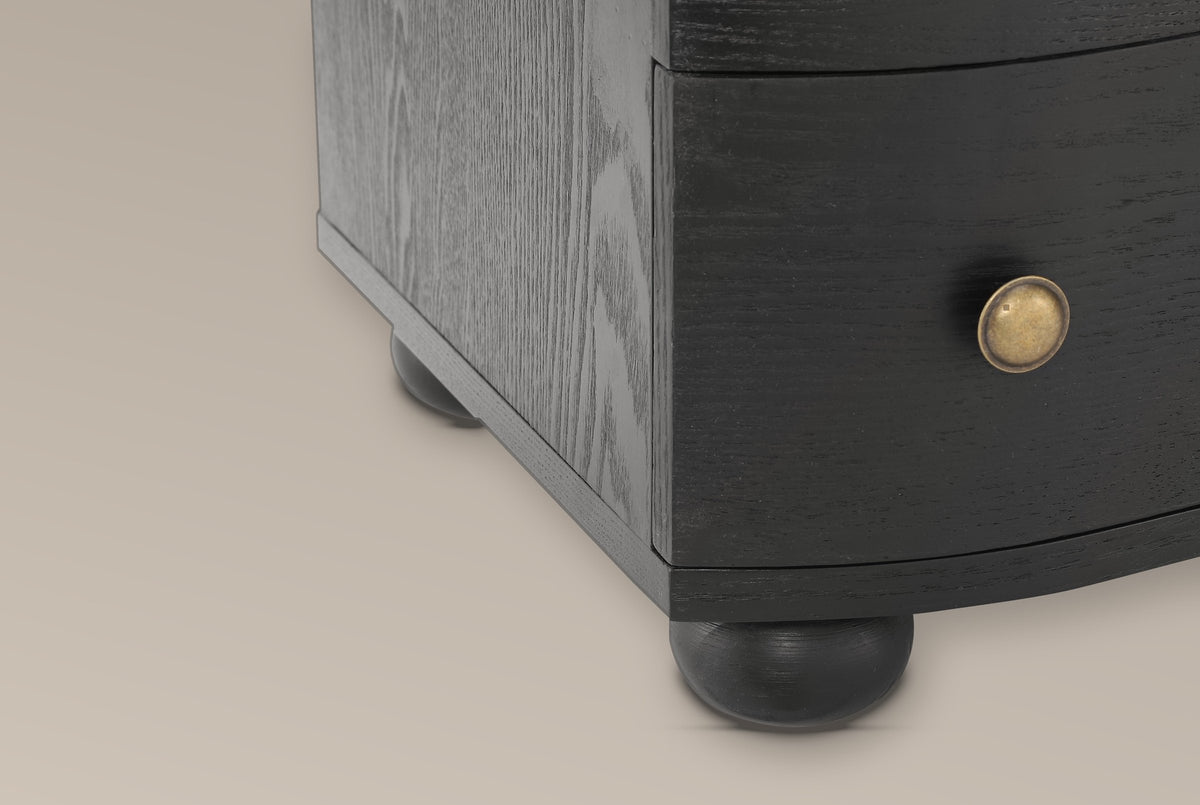 Close-up of the Merano base in Black: the bottom drawer with its antique-brass knob