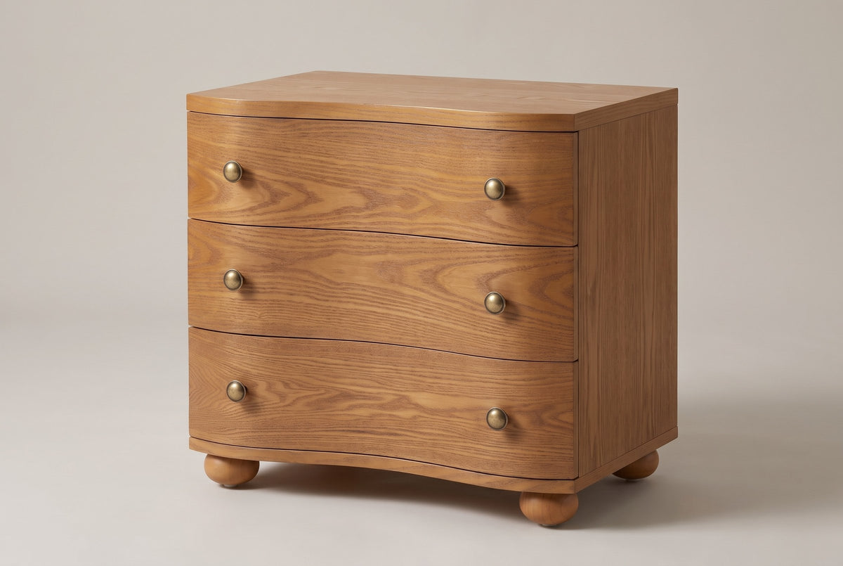 Merano 3-drawer nightstand in Honey Brown ash, three-quarter view on a warm grey studio backdrop