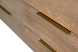 Close-up of Merritt's slim brass-finish bar pulls on Sand oak drawers