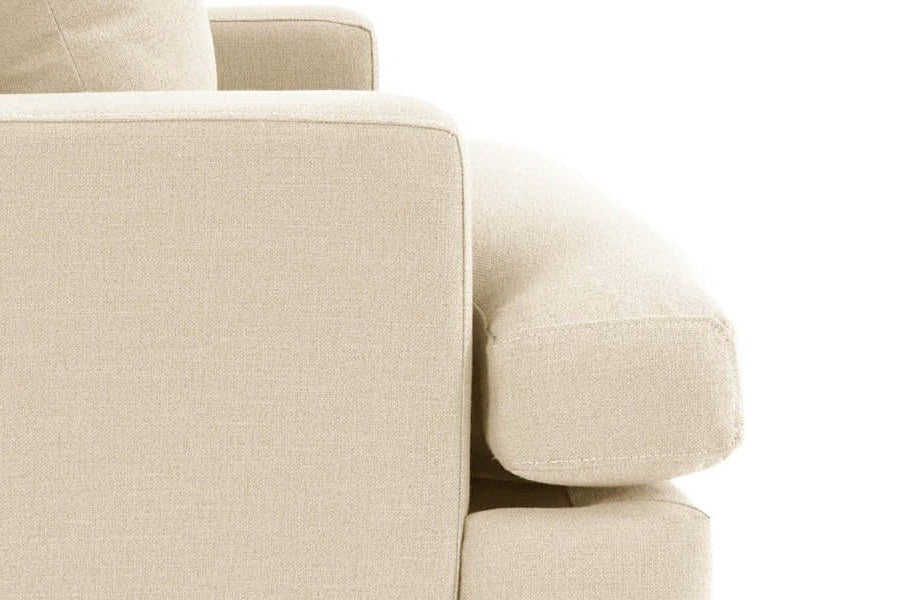 Close-up of the rounded Mombaruzzo seat cushion running past the arm, the base below and a tapered leg