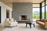 Mombaruzzo accent chair in a Mansonville house in the Missisquoi valley, Quebec, by a fieldstone fireplace wall
