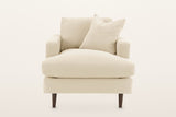 Mombaruzzo accent chair, straight front view on a warm white studio backdrop: the wide seat cushion running the full width