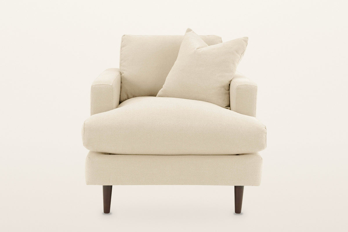 Mombaruzzo accent chair, straight front view on a warm white studio backdrop: the wide seat cushion running the full width
