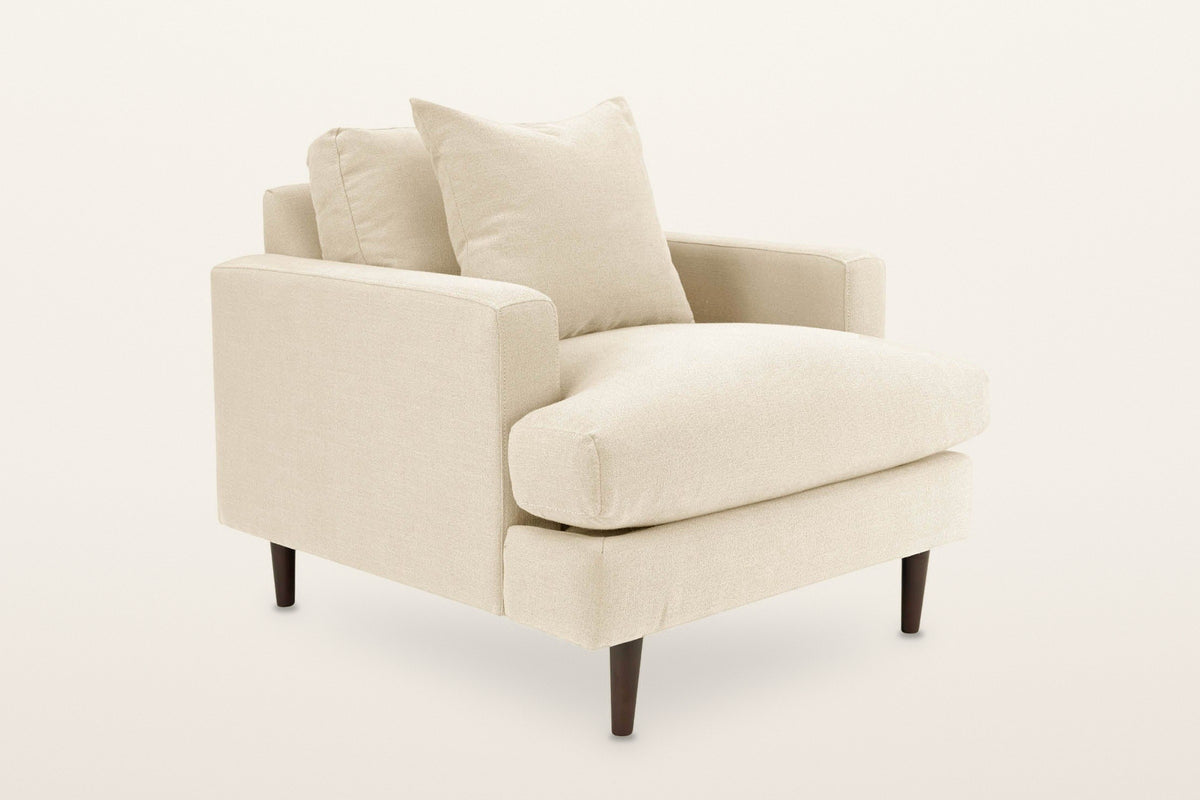 Mombaruzzo track arm accent chair in Beach Alabaster, three-quarter view on a warm white studio backdrop: slim square arms