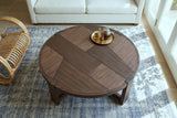 The Mondavio patchwork top in Smoked Acacia seen from above in a Granada house, on an indigo rug with a brass tea tray