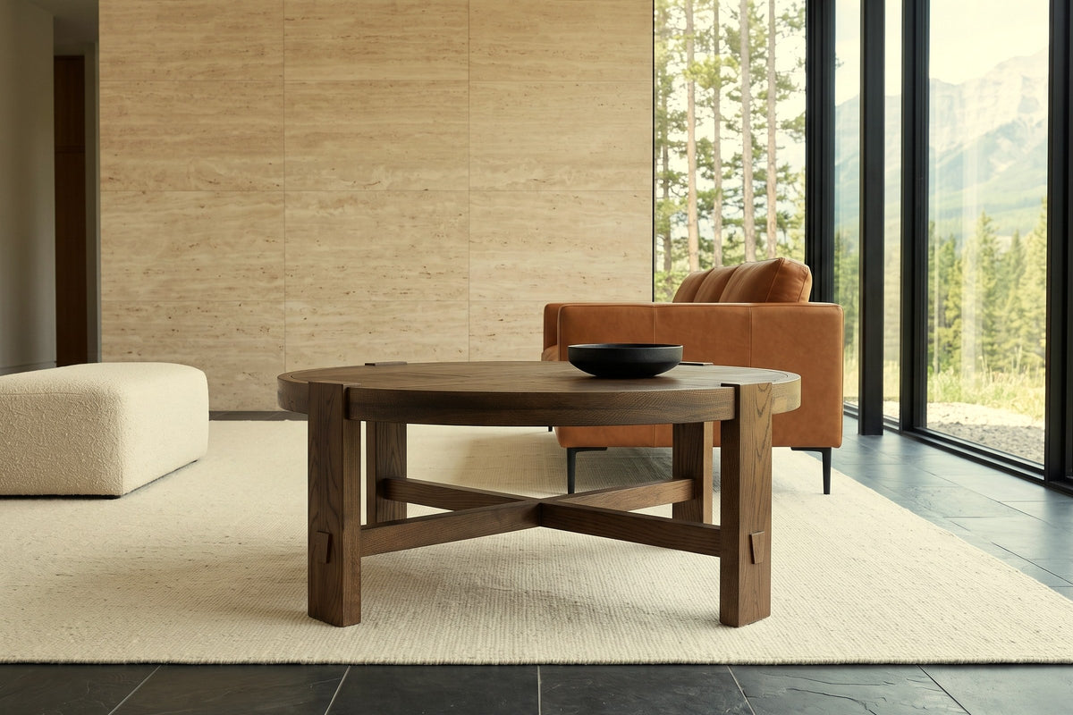 Mondavio coffee table in Smokey Chestnut seen low from the front in a Hinton mountain house, with a travertine wall