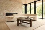 Mondavio coffee table in Smokey Chestnut seen from above in a Saint-Sauveur house, with a dry-stack limestone wall