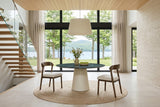 Two Mondavio dining chairs at a round green marble table on a plaster pedestal in a house above Lake Memphremagog in Magog
