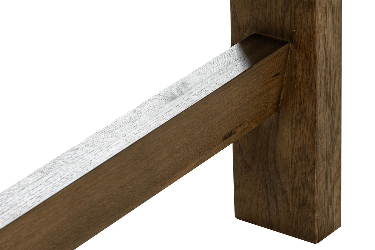 Close-up of a Mondavio leg in Smokey Chestnut: a flat oak leg to the floor, the low end bar joining it