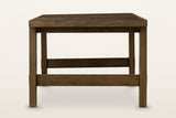 Mondavio dining table in Smokey Chestnut, end view on a warm white studio backdrop: two flat legs