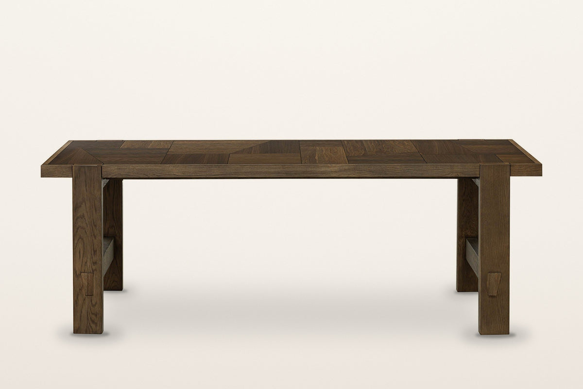 Mondavio patchwork oak dining table in Smokey Chestnut, front view from slightly above on a warm white studio backdrop