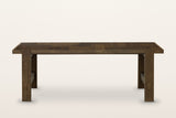 Mondavio patchwork oak dining table in Smokey Chestnut, front view from slightly above on a warm white studio backdrop