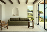 Mondavio side table in Smokey Chestnut at the end of an olive linen sofa in an Ischia villa, with white lime plaster