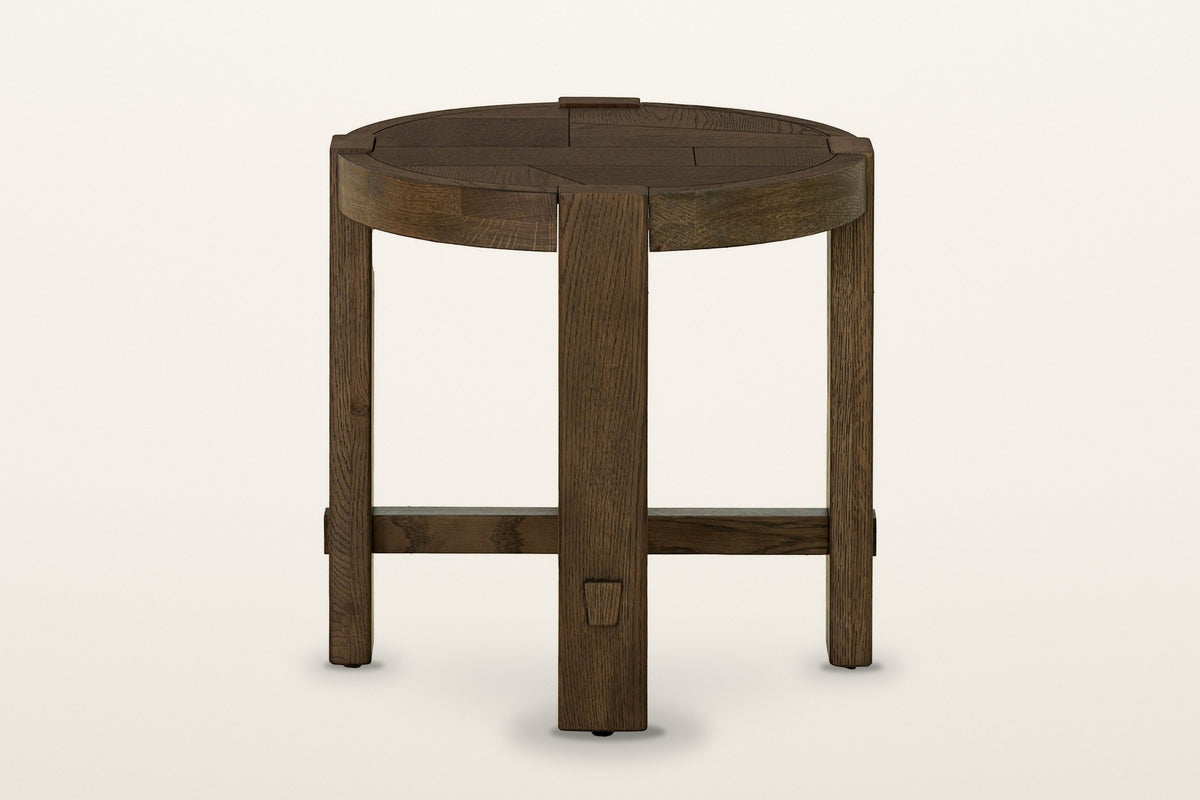 Mondavio round oak side table in Smokey Chestnut on a warm white studio backdrop