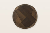 The Mondavio top seen from above in Smokey Chestnut: an oak mosaic inside a round rim