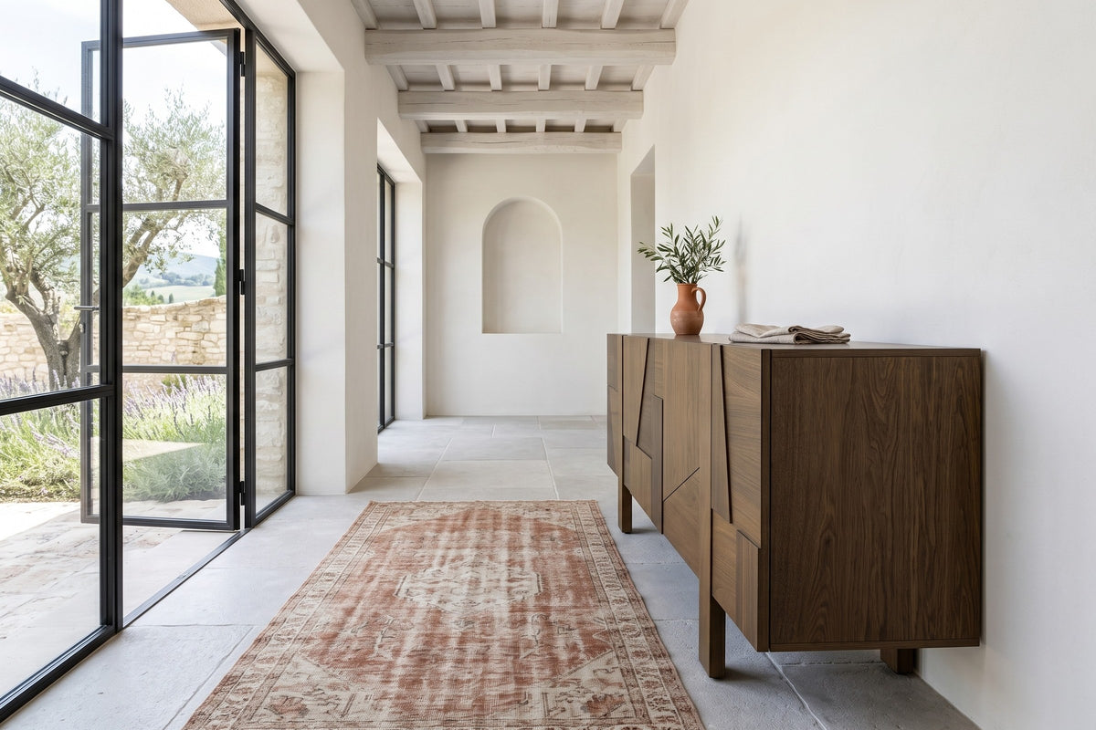 Mondavio sideboard in Smokey Chestnut seen from the end in a white plaster hallway in Spello, with whitewashed beams